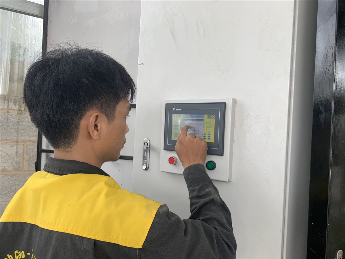 Operator using the PLC touch screen of an automatic car wash machine